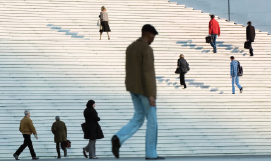 A picture containing people walking up steps